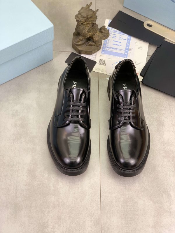 Prada black patent-leather derby shoe.