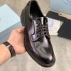 Prada black patent-leather derby shoe.