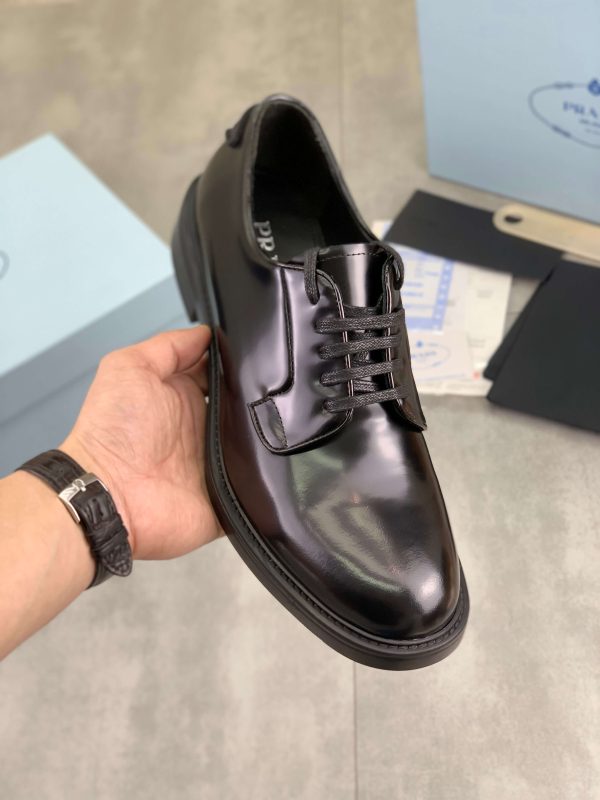 Prada black patent-leather derby shoe.