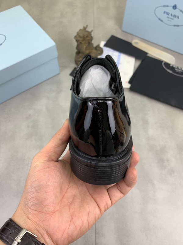 Prada black patent-leather derby shoe.