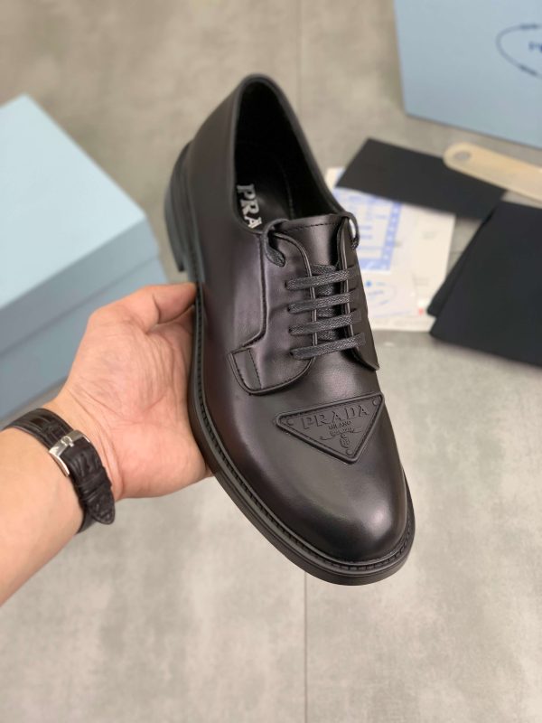 Prada black patent-leather derby shoe. (2) Prada black patent-leather derby shoe.