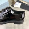 Prada black patent-leather derby shoe.