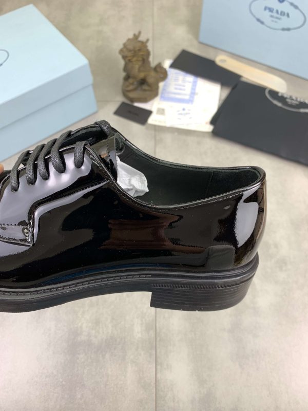 Prada black patent-leather derby shoe.