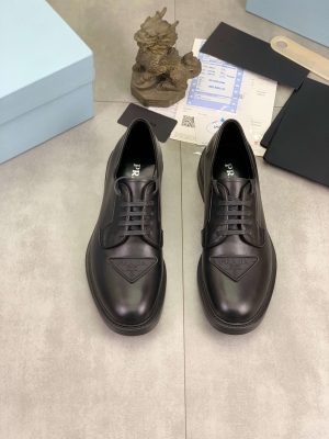 Prada black patent-leather derby shoe.
