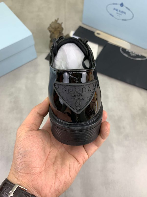 Prada black patent-leather derby shoe. (3) Prada black patent-leather derby shoe.