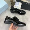 Prada black patent-leather derby shoe.