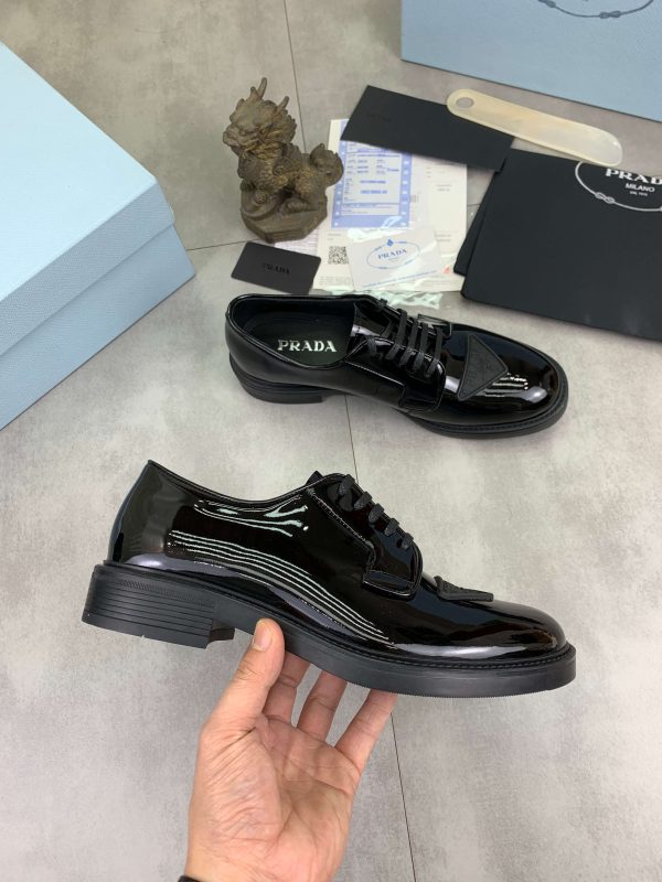 Prada black patent-leather derby shoe.