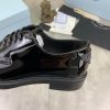 Prada black patent-leather derby shoe. (4) Prada black patent-leather derby shoe.