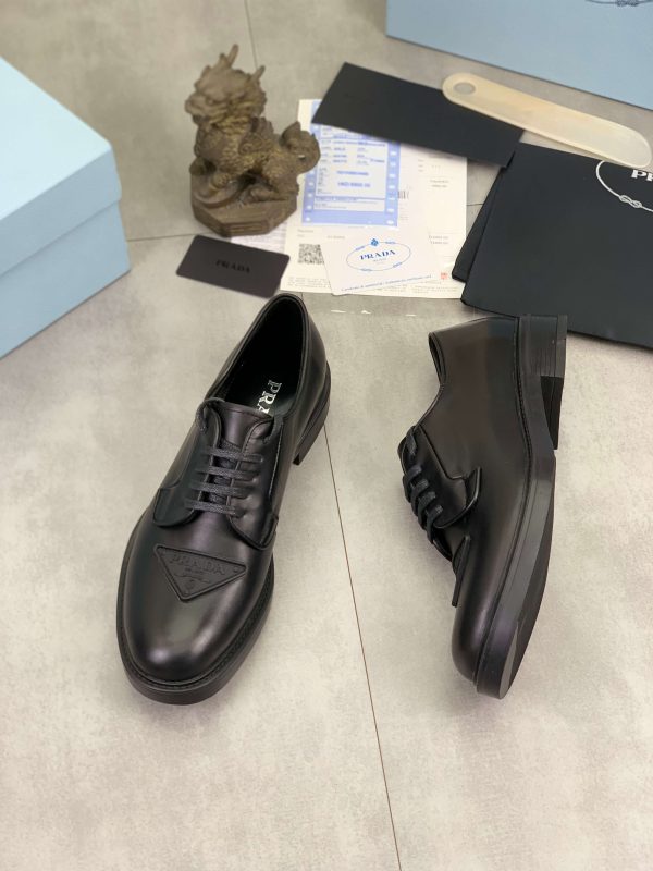 Prada black patent-leather derby shoe. (4) Prada black patent-leather derby shoe.