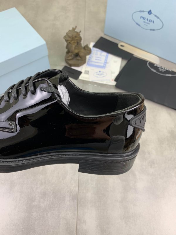 Prada black patent-leather derby shoe. (4) Prada black patent-leather derby shoe.
