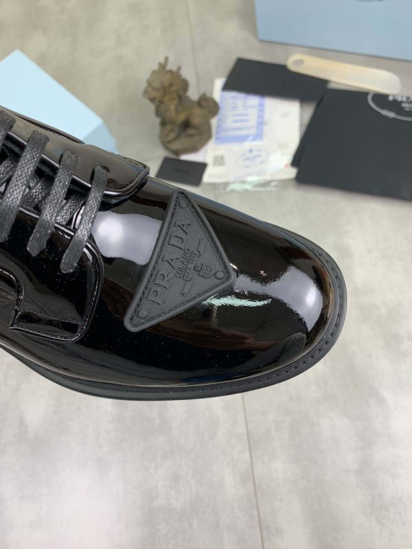 Prada black patent-leather derby shoe.
