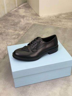 Prada black patent-leather derby shoe. (5) Prada black patent-leather derby shoe.