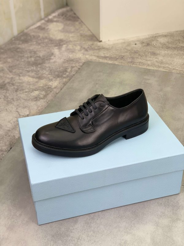 Prada black patent-leather derby shoe. (5) Prada black patent-leather derby shoe.