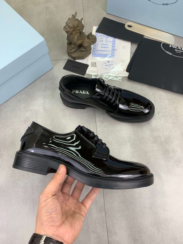 Prada black patent-leather derby shoe. (5) Prada black patent-leather derby shoe.