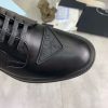 Prada black patent-leather derby shoe. (6) Prada black patent-leather derby shoe.