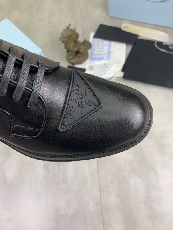 Prada black patent-leather derby shoe. (6) Prada black patent-leather derby shoe.
