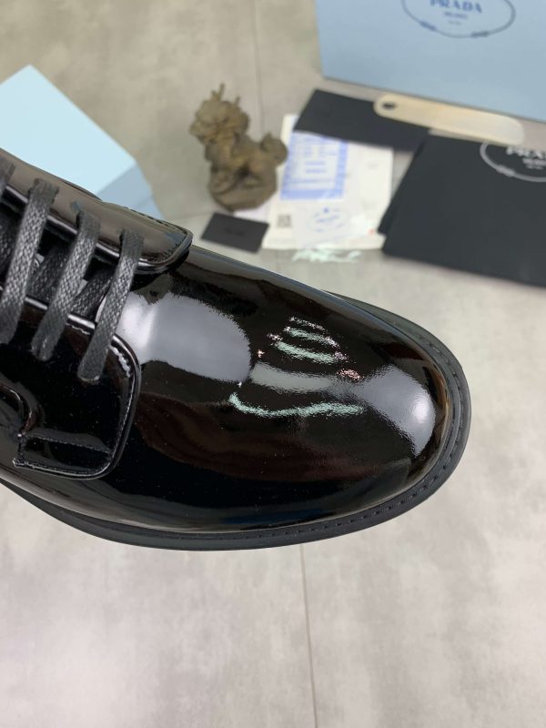 Prada black patent-leather derby shoe. (6) Prada black patent-leather derby shoe.