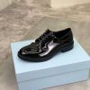 Prada black patent-leather derby shoe.