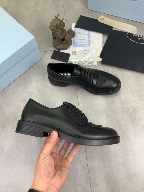 Prada black patent-leather derby shoe. (7) Prada black patent-leather derby shoe.