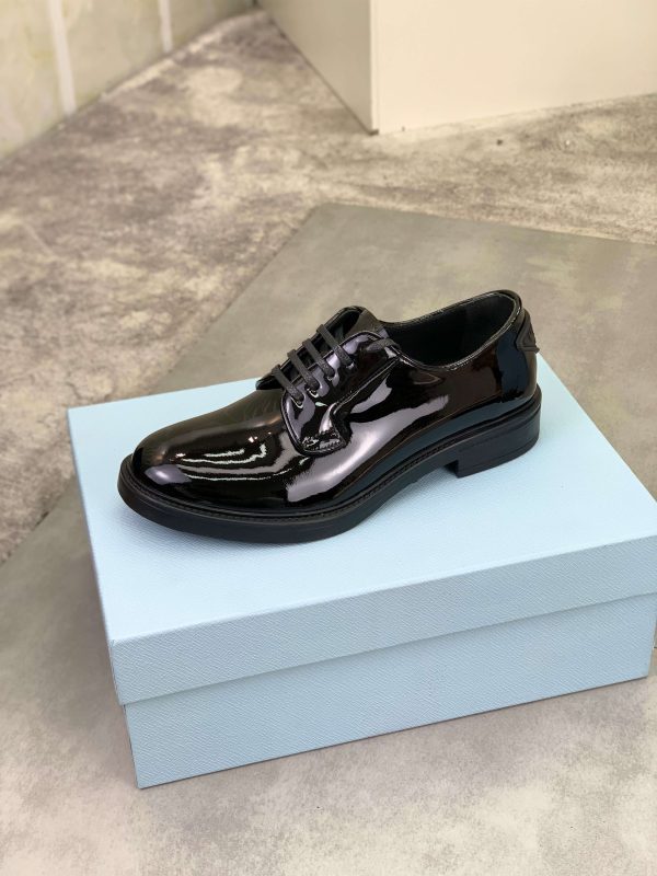 Prada black patent-leather derby shoe. (7) Prada black patent-leather derby shoe.