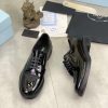 Prada black patent-leather derby shoe.
