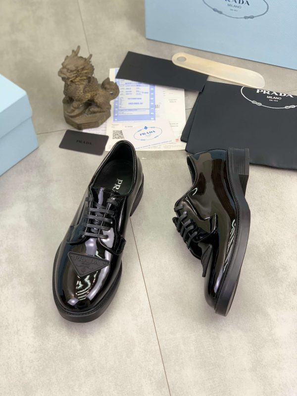Prada black patent-leather derby shoe.