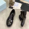 Prada black patent-leather derby shoe. (8) Prada black patent-leather derby shoe.