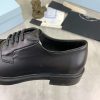 Prada black patent-leather derby shoe. (8) Prada black patent-leather derby shoe.