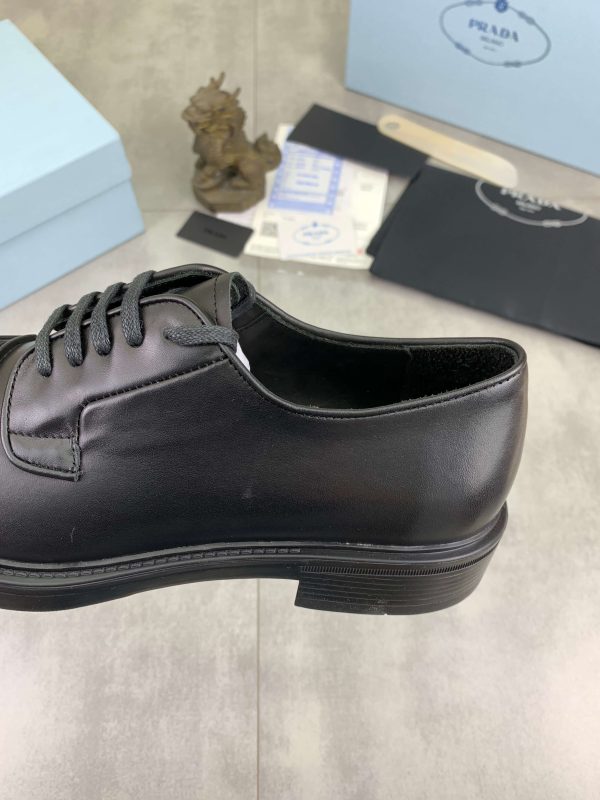 Prada black patent-leather derby shoe. (8) Prada black patent-leather derby shoe.