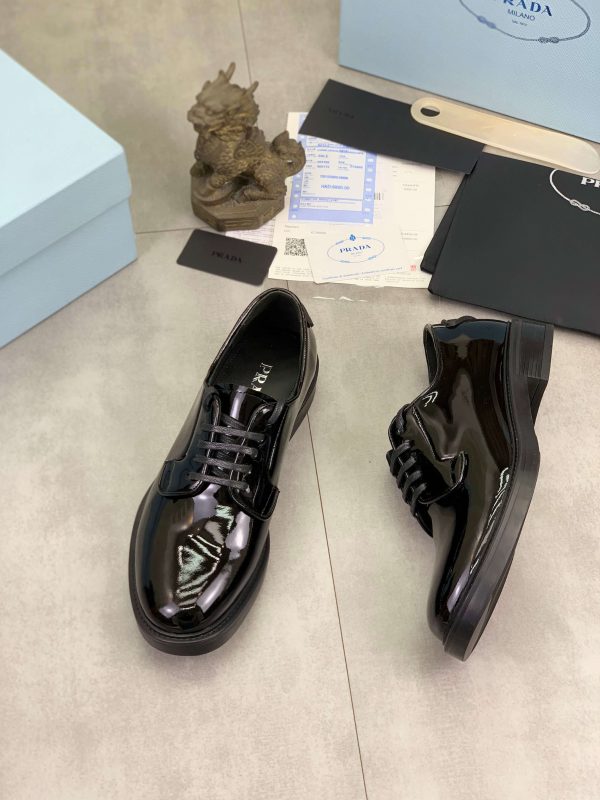 Prada black patent-leather derby shoe. (8) Prada black patent-leather derby shoe.