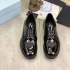 Prada black patent-leather derby shoe.