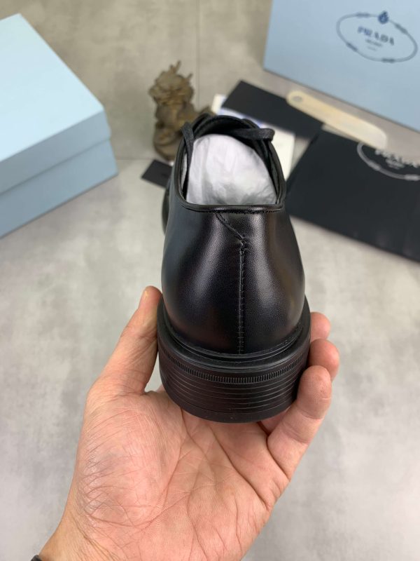 Prada black patent-leather derby shoe. (9) Prada black patent-leather derby shoe.