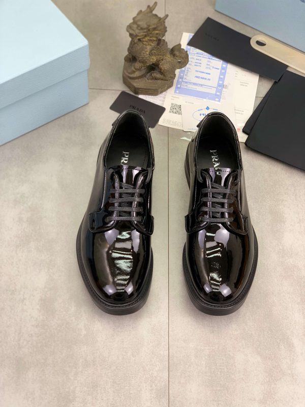 Prada black patent-leather derby shoe. (9) Prada black patent-leather derby shoe.