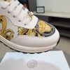 Versace Jeans Couture white and gold Barocco-print low-top sneakers.
