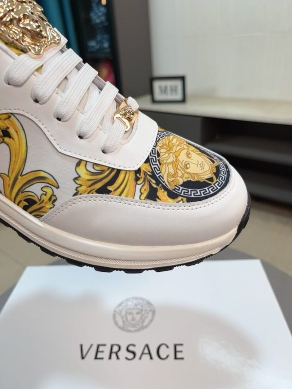 Versace Jeans Couture white and gold Barocco-print low-top sneakers.
