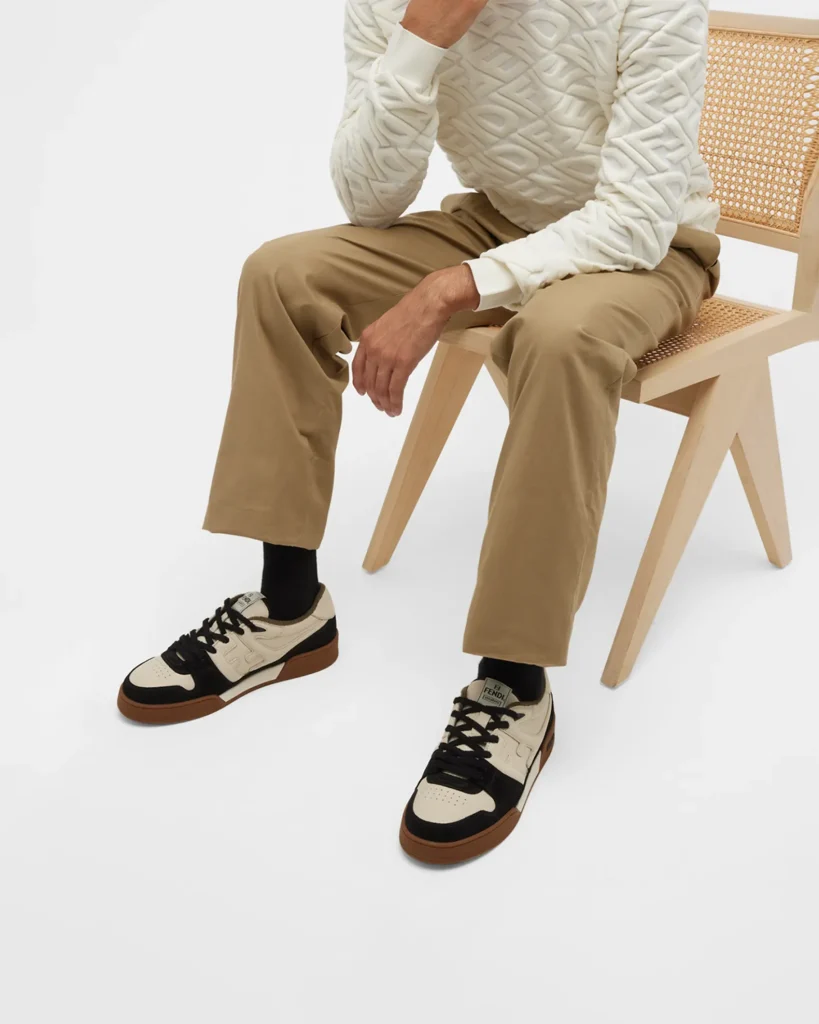 A man wearing a pair of FENDI FF sneakers