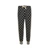 Front view of dark navy and ivory Gucci GG jacquard track pants featuring an elastic drawstring waist and striped ribbed ankle cuffs.