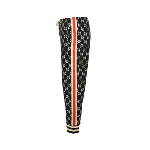 Side profile view of Gucci GG Jacquard Track Pants showing red and ivory side stripes and all-over monogram pattern.