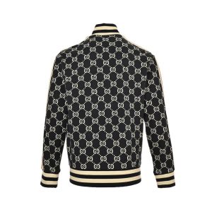 Back view of a dark navy Gucci GG Jacquard track jacket highlighting the continuous interlocking monogram pattern and striped ribbed hem.