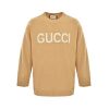 Front view of the Gucci Intarsia Logo Knit Crewneck Jumper in camel featuring prominent white block lettering across the chest.