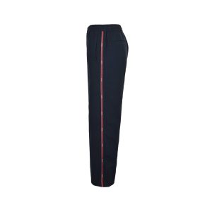 Side profile view of Gucci technical navy trousers highlighting the contrasting red athletic stripe running down the outer leg.