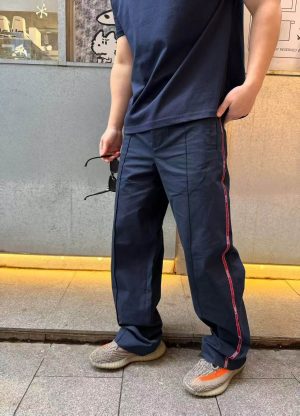 Front view of the Gucci Technical Panama Sportswear Trousers in Dark Navy, showcasing the straight leg fit and prominent front center creases.