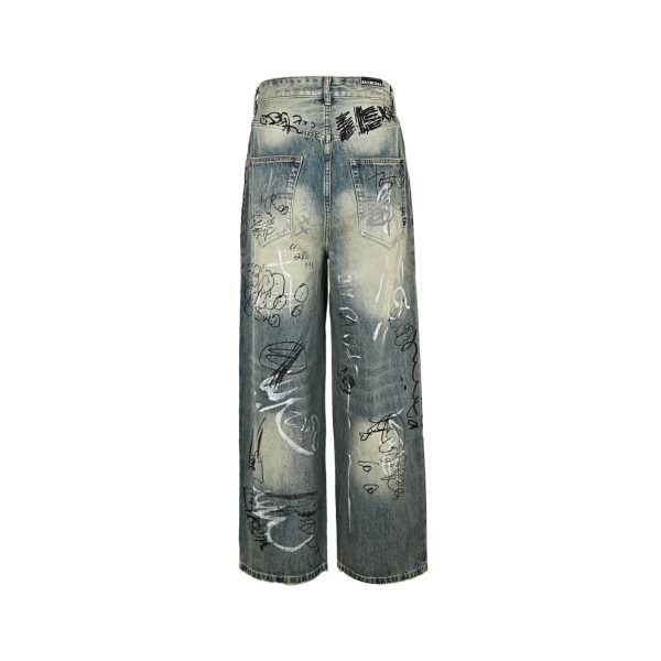 Balenciaga Graffiti Baggy Jeans in Faded Blue (6) Back view of the faded blue Balenciaga Graffiti Baggy Jeans showing all-over black and white scribble graphics and a black waistband patch.