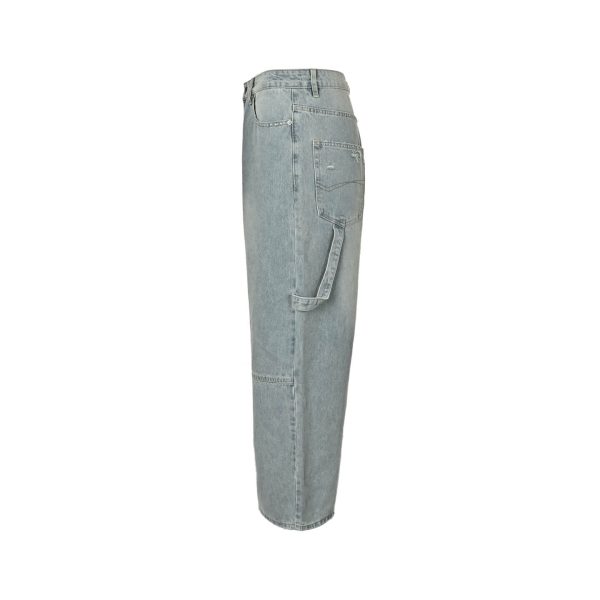 Side profile view of the Balenciaga light blue denim highlighting the oversized fit, horizontal knee seam, and side hammer loop.