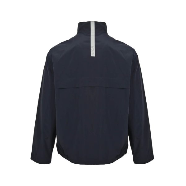 Back view of the Dior blouson jacket highlighting the horizontal yoke and the vertical Dior stripe on the back of the neck.