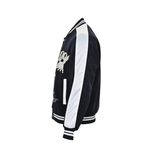 Louis Vuitton Denim Velvet Souvenir Jacket in Midnight Blue and White (4) Side profile view highlighting the contrasting white sleeve, striped ribbed cuffs, and textured denim velvet body.