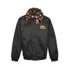 Front view of the black LV collaborative aviator jacket featuring a custom embroidered chest logo, hidden placket, and plush monogram collar.