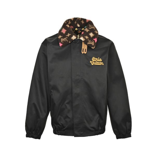 Front view of the black LV collaborative aviator jacket featuring a custom embroidered chest logo, hidden placket, and plush monogram collar.